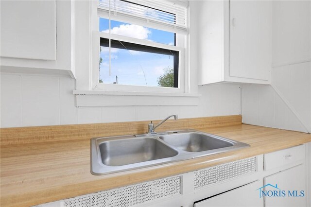308 Crittenden Ave, Toledo, OH 43609 - kitchen with a sink, white cabinetry, and light countertops