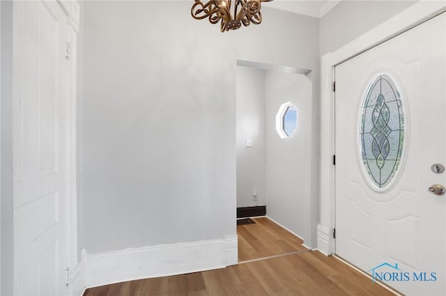 308 Crittenden Ave, Toledo, OH 43609 - entryway with a chandelier, wood finished floors, and ornamental molding