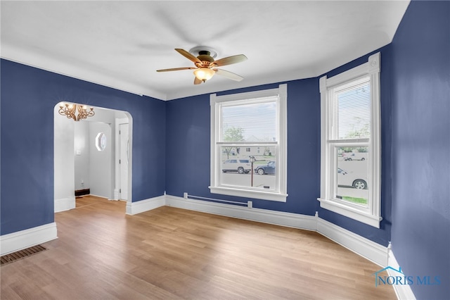 308 Crittenden Ave, Toledo, OH 43609 - empty room with ceiling fan, arched walkways, wood finished floors, and baseboards