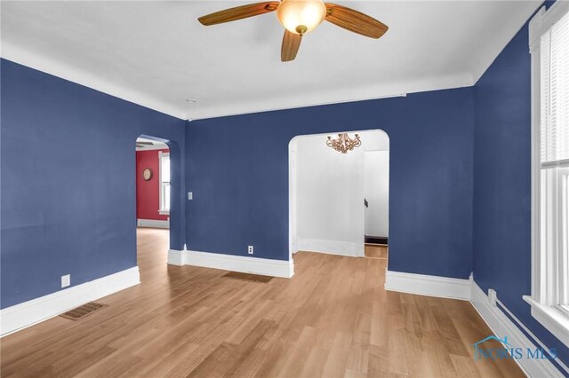 308 Crittenden Ave, Toledo, OH 43609 - unfurnished room with arched walkways, a ceiling fan, wood finished floors, and baseboards