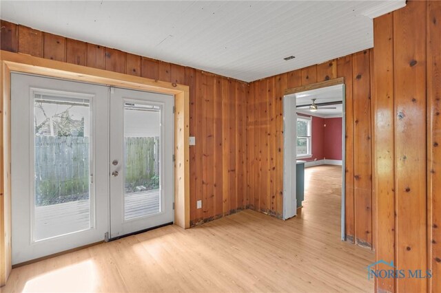 308 Crittenden Ave, Toledo, OH 43609 - doorway to outside featuring french doors, light wood-style floors, and wood walls