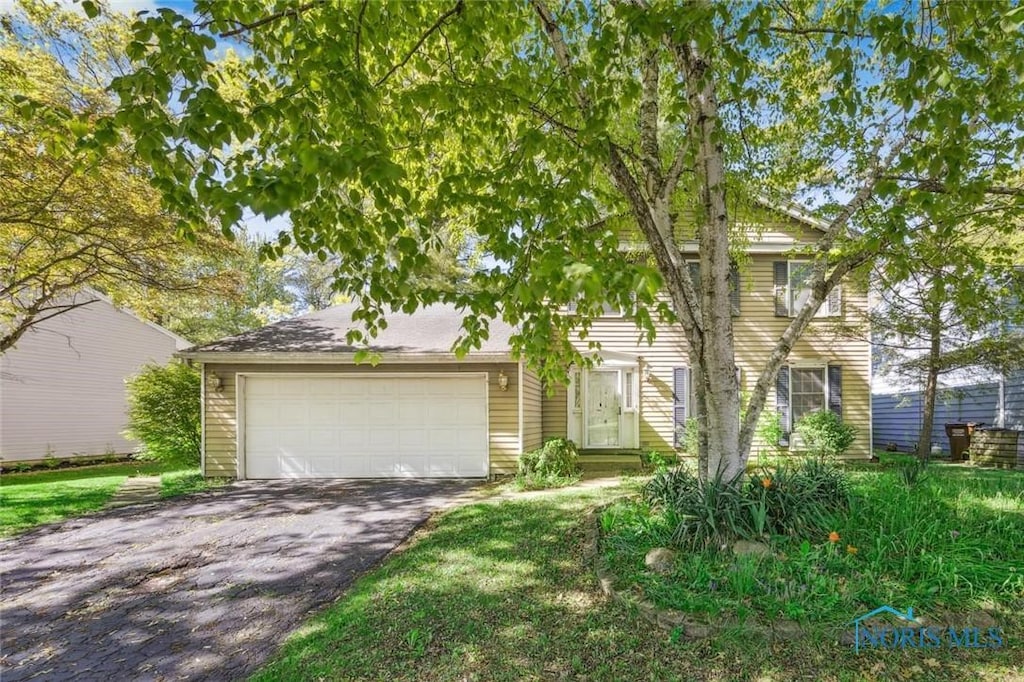 6120 W Pembridge Dr, Toledo, OH 43615 - view of front of house featuring asphalt driveway and an attached garage