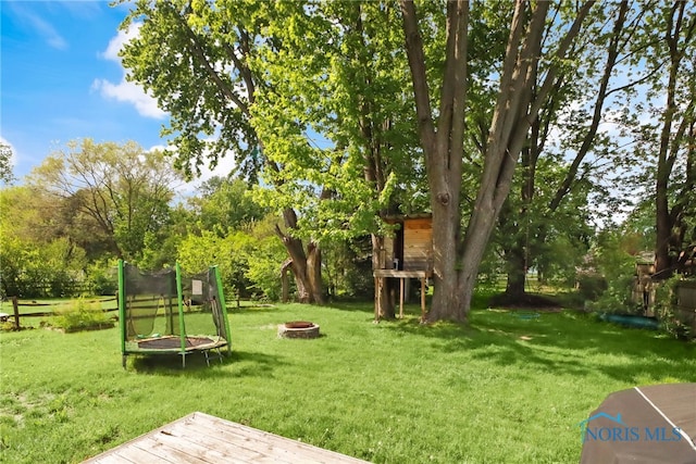 5956 E Pembridge Dr, Toledo, OH 43615 - view of home's community with a fire pit, a lawn, view of wooded area, and a deck