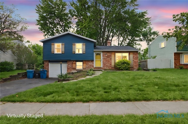 5956 E Pembridge Dr, Toledo, OH 43615 - tri-level home featuring brick siding, asphalt driveway, a chimney, and a garage