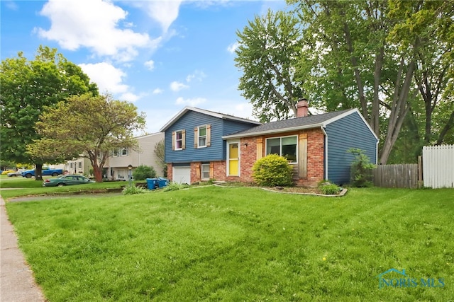 5956 E Pembridge Dr, Toledo, OH 43615 - tri-level home featuring brick siding, a chimney, and an attached garage