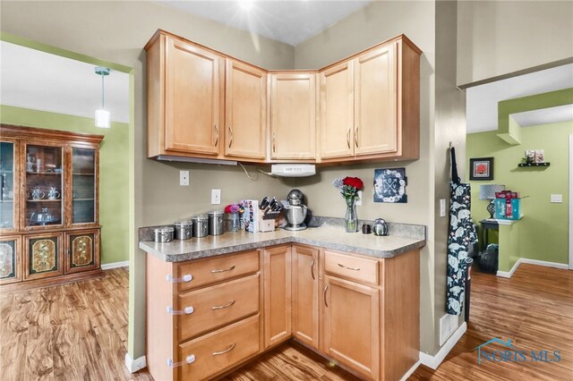 5956 E Pembridge Dr, Toledo, OH 43615 - kitchen with light brown cabinetry, wood finished floors, and baseboards