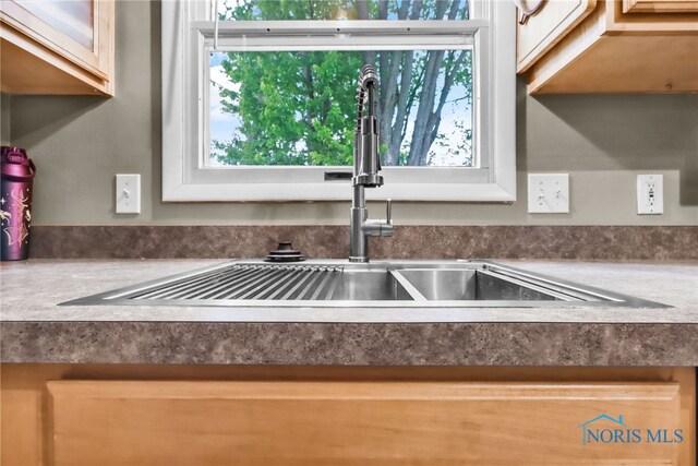 5956 E Pembridge Dr, Toledo, OH 43615 - kitchen view of a sink, white cabinets, and dark countertops