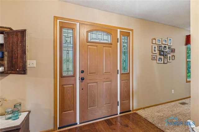 8012 County Highway 55, Upper Sandusky, OH 43351 - entrance foyer featuring dark wood-style flooring, baseboards, and a textured ceiling