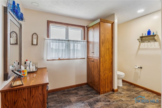 8012 County Highway 55, Upper Sandusky, OH 43351 - bathroom with baseboards, toilet, and stone finish flooring