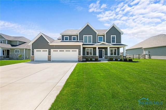 9575 Newbury Ln, Whitehouse, OH 43571 - view of front of home featuring concrete driveway, stone siding, covered porch, and an attached garage