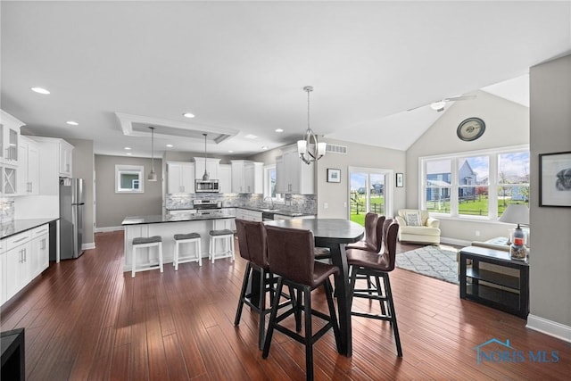 9575 Newbury Ln, Whitehouse, OH 43571 - dining room with dark wood-type flooring, healthy amount of natural light, recessed lighting, and a chandelier