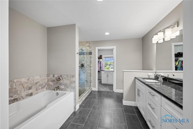 9575 Newbury Ln, Whitehouse, OH 43571 - full bathroom featuring vanity, a stall shower, a garden tub, tile patterned flooring, and baseboards