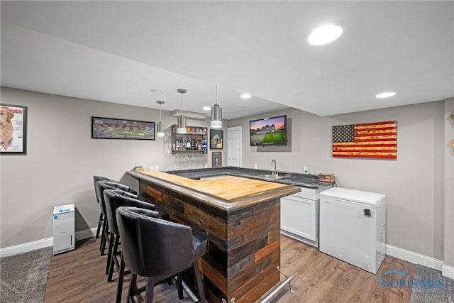 9575 Newbury Ln, Whitehouse, OH 43571 - indoor wet bar featuring refrigerator, baseboards, wood finished floors, recessed lighting, and hanging light fixtures