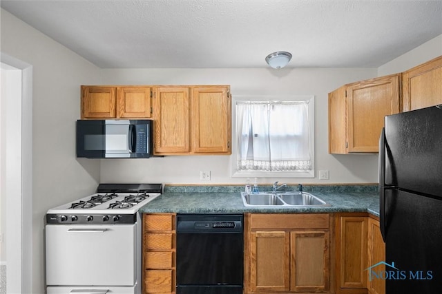 kitchen featuring black appliances, a sink, and dark countertops