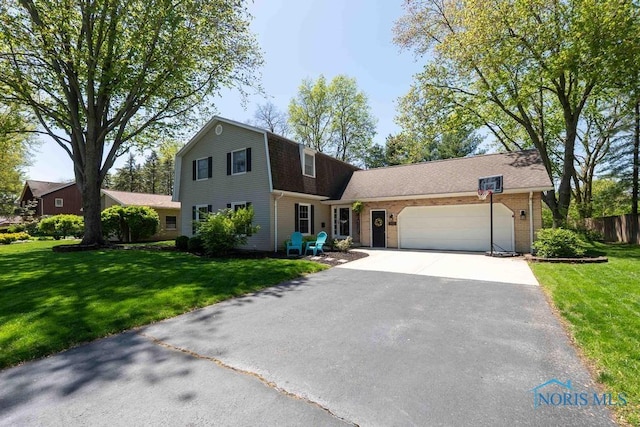 2057 Windsor Pl, Findlay, OH 45840 - colonial inspired home featuring asphalt driveway, a garage, and a gambrel roof