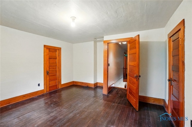 7438 Yawberg Rd, Whitehouse, OH 43571 - unfurnished bedroom featuring baseboards and dark wood-style floors