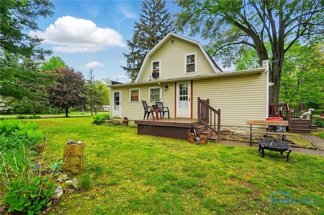 7438 Yawberg Rd, Whitehouse, OH 43571 - rear view of property with a fire pit, a wooden deck, a yard, and a gambrel roof