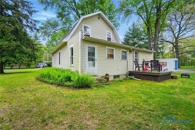 7438 Yawberg Rd, Whitehouse, OH 43571 - rear view of house featuring a wooden deck, a lawn, and a gambrel roof
