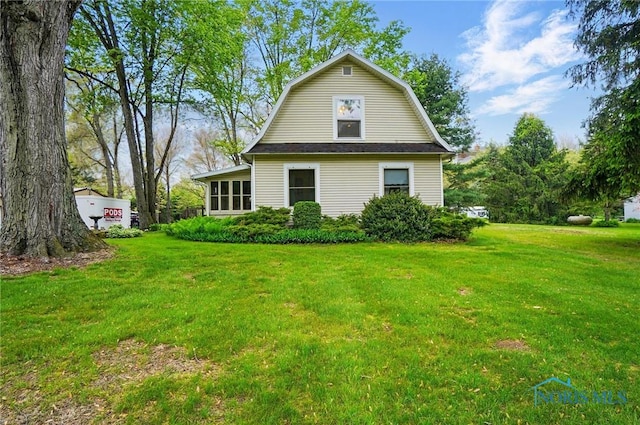7438 Yawberg Rd, Whitehouse, OH 43571 - back of house with a lawn and a gambrel roof