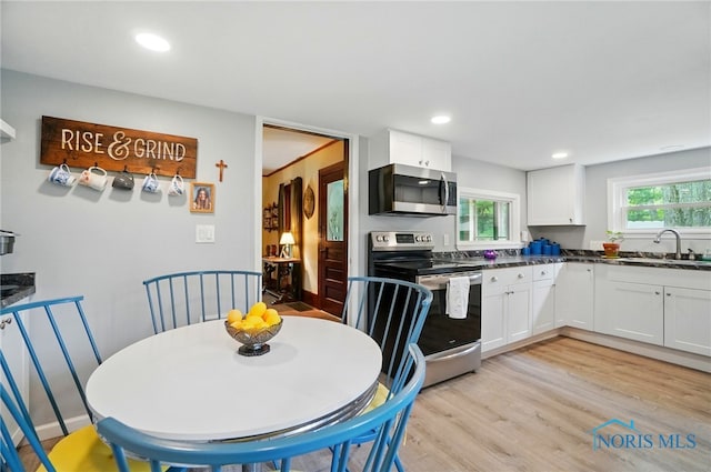 7438 Yawberg Rd, Whitehouse, OH 43571 - kitchen with stainless steel appliances, a sink, white cabinets, dark countertops, and recessed lighting