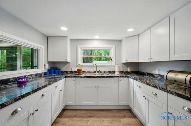 7438 Yawberg Rd, Whitehouse, OH 43571 - kitchen with a sink, white cabinets, light wood-type flooring, dark stone counters, and recessed lighting