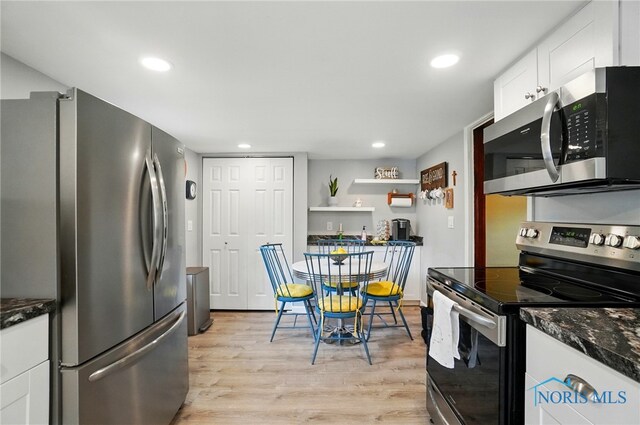 7438 Yawberg Rd, Whitehouse, OH 43571 - kitchen featuring stainless steel appliances, light wood-type flooring, white cabinetry, recessed lighting, and dark stone counters