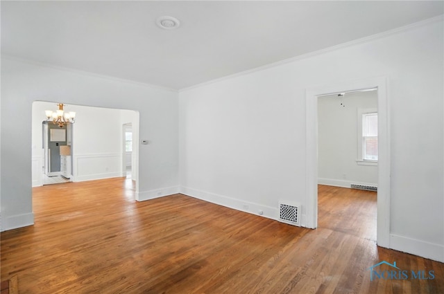 4315 Eastway St, Toledo, OH 43612 - unfurnished room featuring a chandelier, ornamental molding, wood finished floors, and baseboards