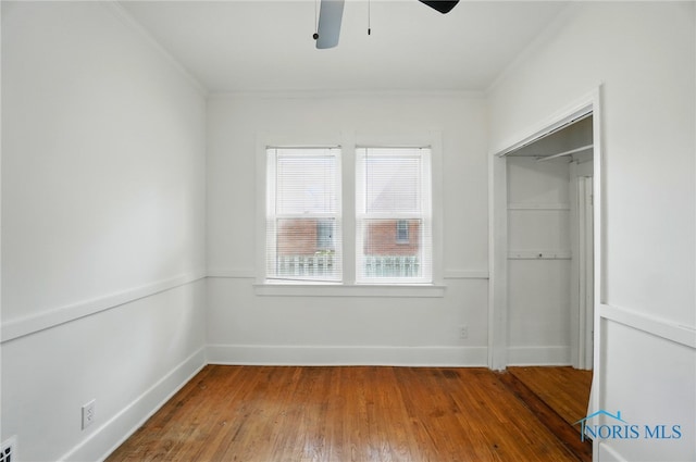 4315 Eastway St, Toledo, OH 43612 - unfurnished bedroom with crown molding, hardwood / wood-style floors, a closet, baseboards, and ceiling fan