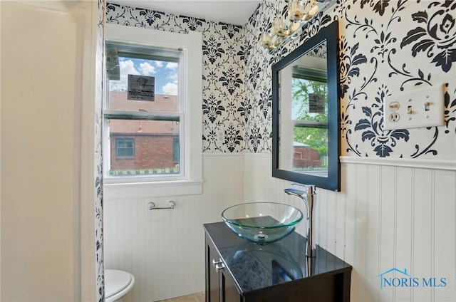 4315 Eastway St, Toledo, OH 43612 - bathroom featuring wainscoting, vanity, toilet, and wallpapered walls
