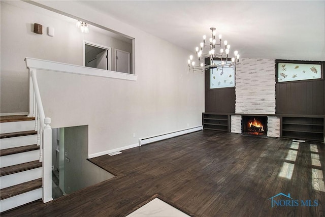 unfurnished living room featuring a baseboard radiator, wood finished floors, stairway, and a chandelier