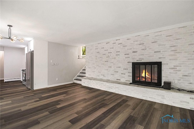unfurnished living room with a baseboard radiator, dark wood-style floors, stairway, baseboards, and a fireplace