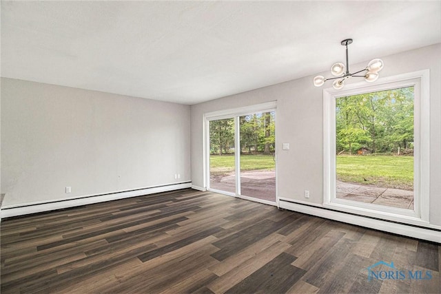 unfurnished dining area with dark wood-style floors, a chandelier, a baseboard heating unit, and baseboards