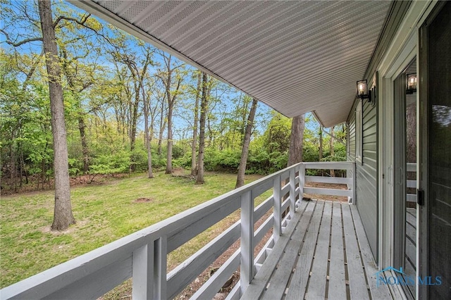 wooden terrace with a yard