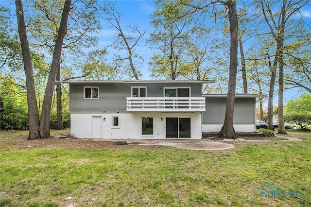 rear view of property with a yard and a patio