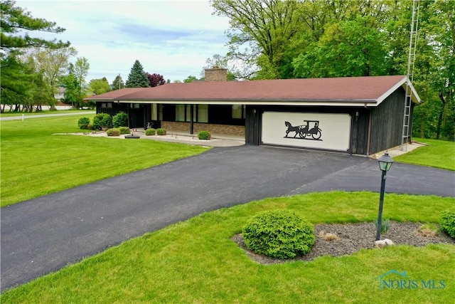 230 Orchard Ln, Upper Sandusky, OH 43351 - ranch-style home featuring a front yard, a garage, a chimney, and driveway