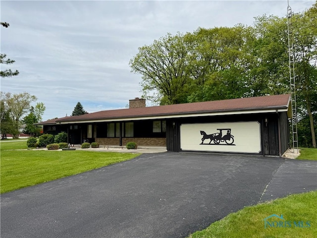 230 Orchard Ln, Upper Sandusky, OH 43351 - single story home featuring an attached garage, driveway, a front lawn, and board and batten siding