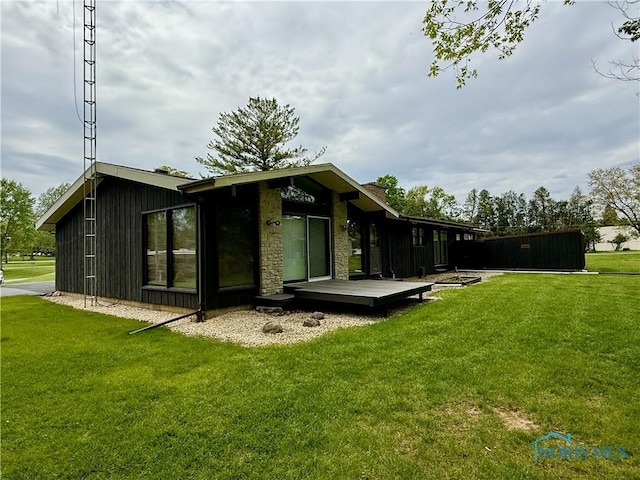 230 Orchard Ln, Upper Sandusky, OH 43351 - rear view of house featuring a wooden deck and a lawn