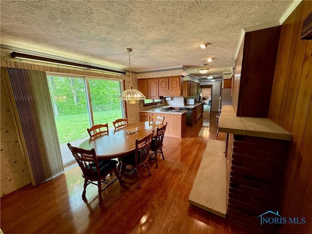 230 Orchard Ln, Upper Sandusky, OH 43351 - dining area with hardwood / wood-style flooring, ornamental molding, a textured ceiling, and wallpapered walls