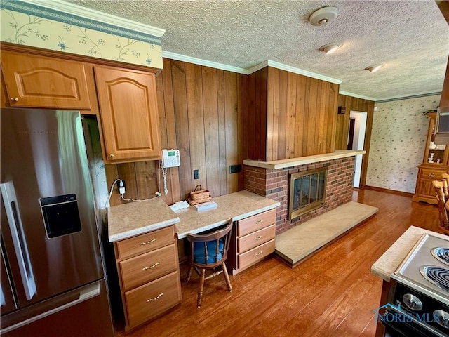 230 Orchard Ln, Upper Sandusky, OH 43351 - kitchen featuring stainless steel refrigerator with ice dispenser, ornamental molding, wood finished floors, light countertops, and electric range oven