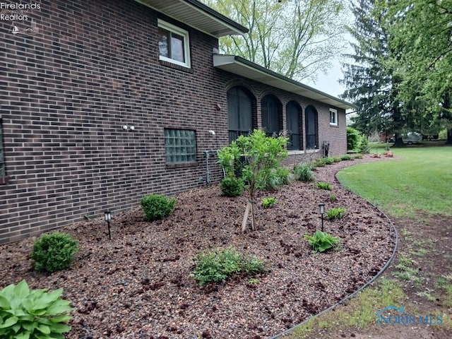 1875 State Route 101, Clyde, OH 43410 - view of side of property featuring brick siding and a yard