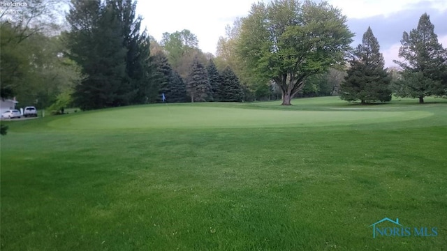 1875 State Route 101, Clyde, OH 43410 - view of property's community featuring view of golf course, a lawn, and view of wooded area