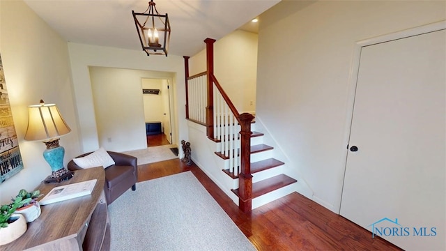 1875 State Route 101, Clyde, OH 43410 - staircase featuring wood finished floors and a chandelier
