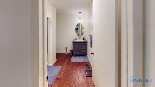 1875 State Route 101, Clyde, OH 43410 - hall featuring wood finished floors, a sink, and baseboards