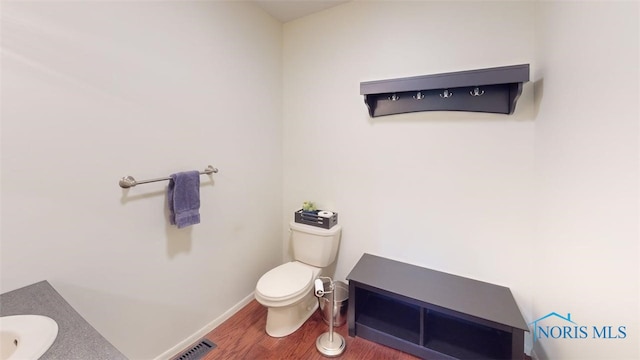 1875 State Route 101, Clyde, OH 43410 - bathroom with wood finished floors, toilet, and baseboards
