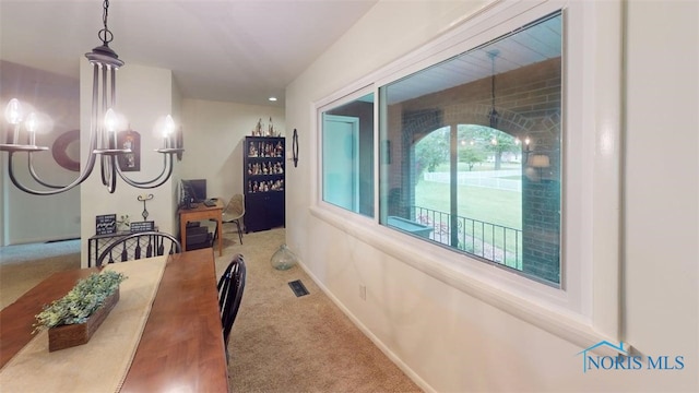 1875 State Route 101, Clyde, OH 43410 - dining space with carpet flooring, a chandelier, and baseboards