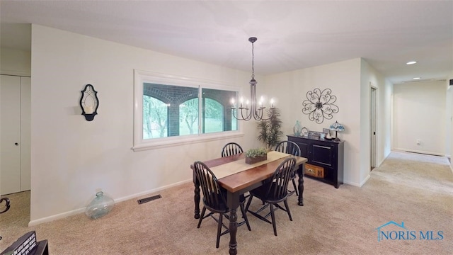 1875 State Route 101, Clyde, OH 43410 - dining space featuring a chandelier, light colored carpet, and baseboards