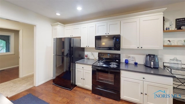 1875 State Route 101, Clyde, OH 43410 - kitchen featuring black appliances, white cabinets, open shelves, dark countertops, and wood finished floors
