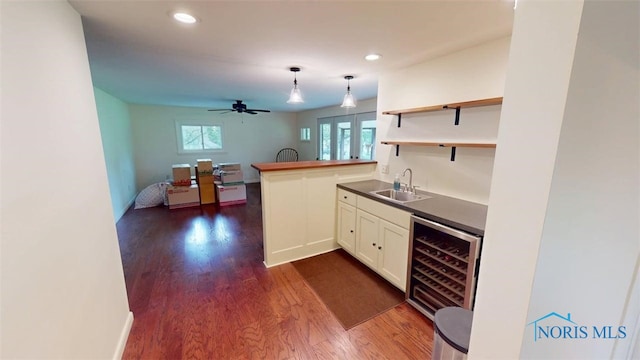 1875 State Route 101, Clyde, OH 43410 - indoor wet bar with wine cooler, dark wood-type flooring, a ceiling fan, hanging light fixtures, and recessed lighting