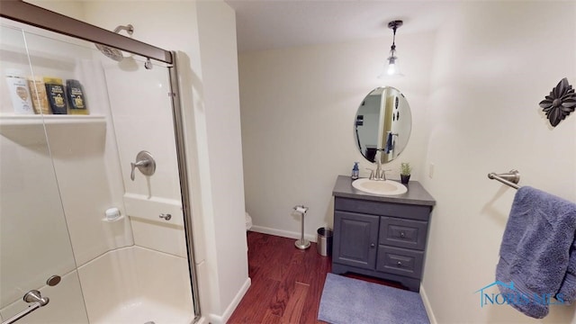 1875 State Route 101, Clyde, OH 43410 - bathroom featuring a shower stall, vanity, wood finished floors, toilet, and baseboards