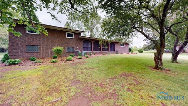 1875 State Route 101, Clyde, OH 43410 - split level home with a front lawn and brick siding
